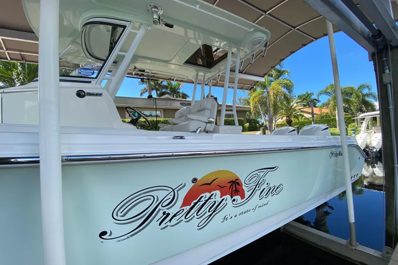 Pretty Fine Yacht Photos Pics 2015 Edgewater 320CC boat docked, featuring "Pretty Fine" graphic and tropical design.