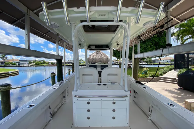 Pretty Fine Yacht Photos Pics 2015 Edgewater 320CC boat interior, docked by a scenic waterfront with clear skies.