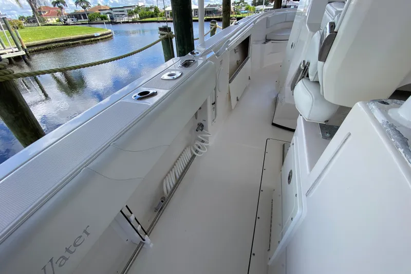 Pretty Fine Yacht Photos Pics 2015 Edgewater 320CC boat interior with white seating and waterfront view.