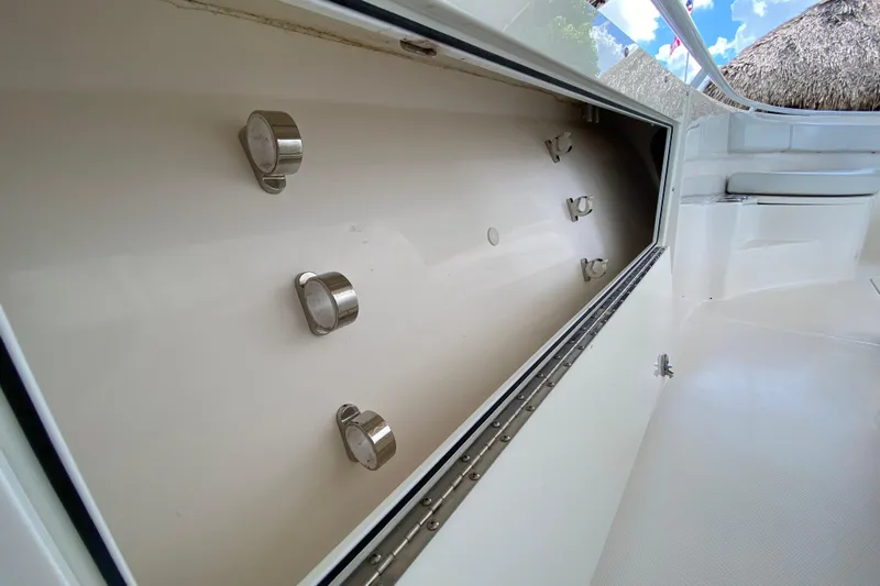 Pretty Fine Yacht Photos Pics 2015 Edgewater 320CC boat storage compartment with metal fixtures, open view.