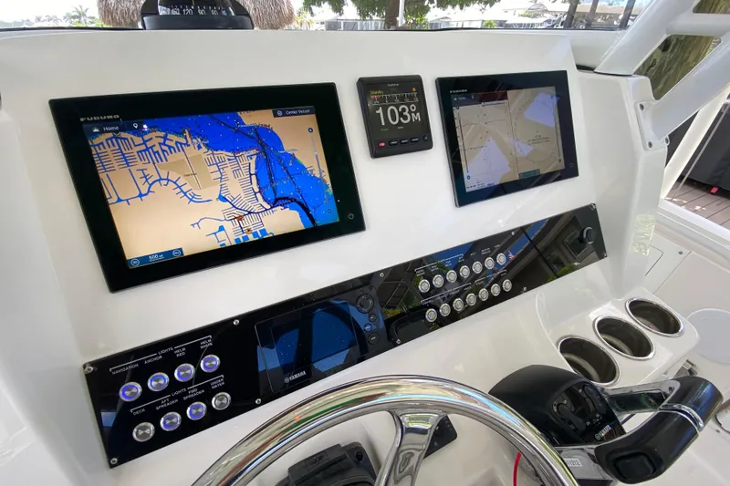 Pretty Fine Yacht Photos Pics Control panel of a 2015 Edgewater 320CC boat with navigation screens and controls.
