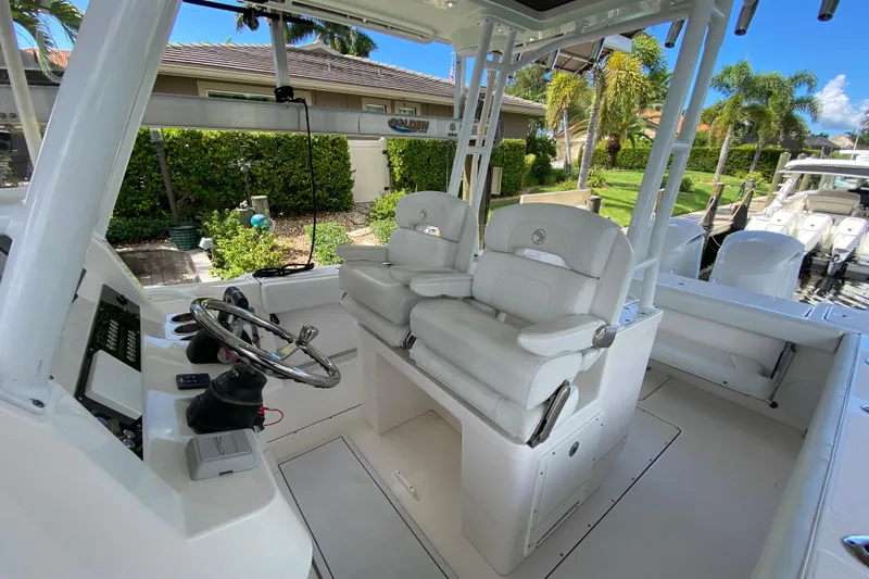 Pretty Fine Yacht Photos Pics 2015 Edgewater 320CC boat interior with helm, dual seats, and modern controls.