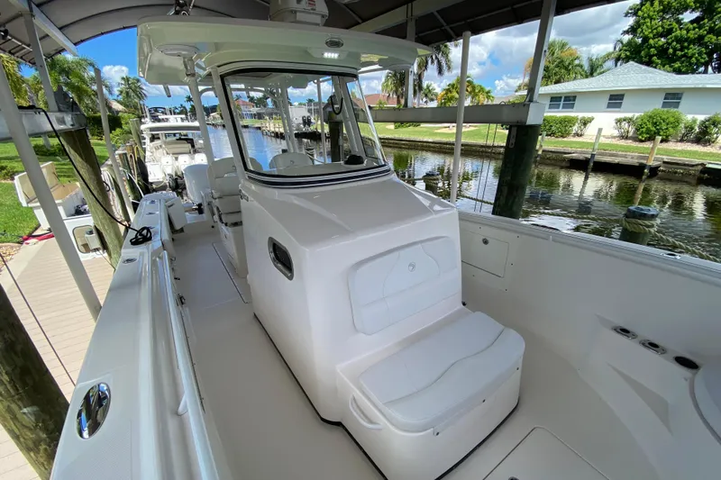 Pretty Fine Yacht Photos Pics 2015 Edgewater 320CC boat docked, featuring spacious seating and sleek design.