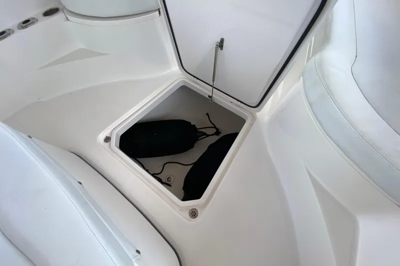 Pretty Fine Yacht Photos Pics 2015 Edgewater 320CC boat storage compartment with open hatch and visible contents.