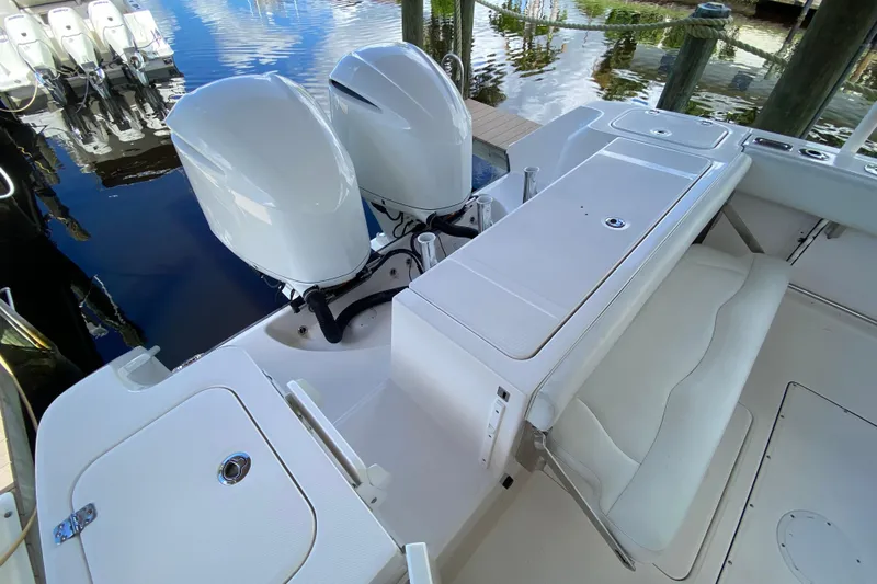 Pretty Fine Yacht Photos Pics 2015 Edgewater 320CC boat with dual outboard engines and white seating area.