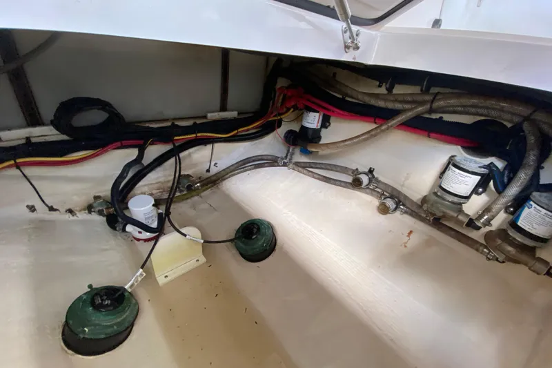 Pretty Fine Yacht Photos Pics Interior view of 2015 Edgewater 320CC boat showing wiring and plumbing components.