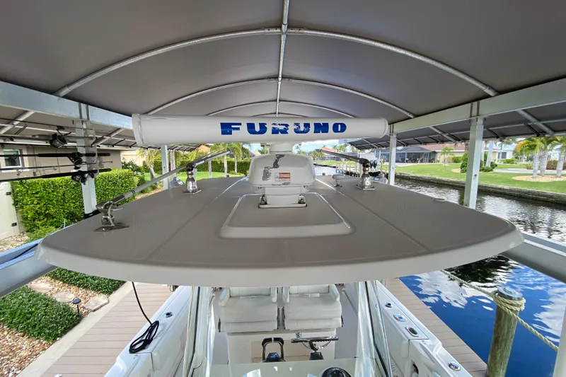 Pretty Fine Yacht Photos Pics 2015 Edgewater 320CC boat with Furuno radar, docked under a canopy.