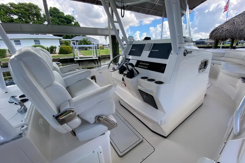 Pretty Fine Yacht Photos Pics 2015 Edgewater 320CC boat interior with helm, white seating, and navigation equipment.