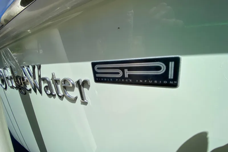 Pretty Fine Yacht Photos Pics 2015 Edgewater 320CC boat with SPI logo, showcasing Single Piece Infusion technology.