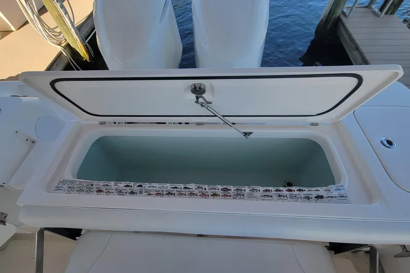 Pretty Fine Yacht Photos Pics Open storage compartment on 2015 Edgewater 320CC boat, dockside view.
