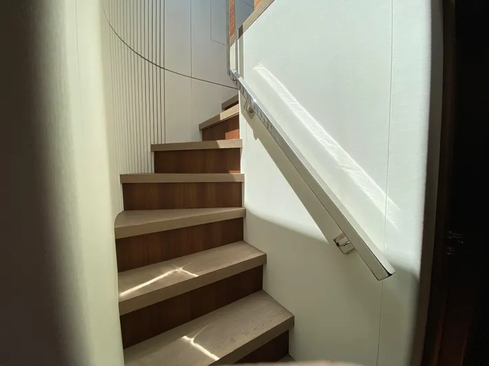 Clb72 Yacht Photos Pics Staircase inside 2023 CL Yachts CLB72, featuring sleek wooden steps and modern design.
