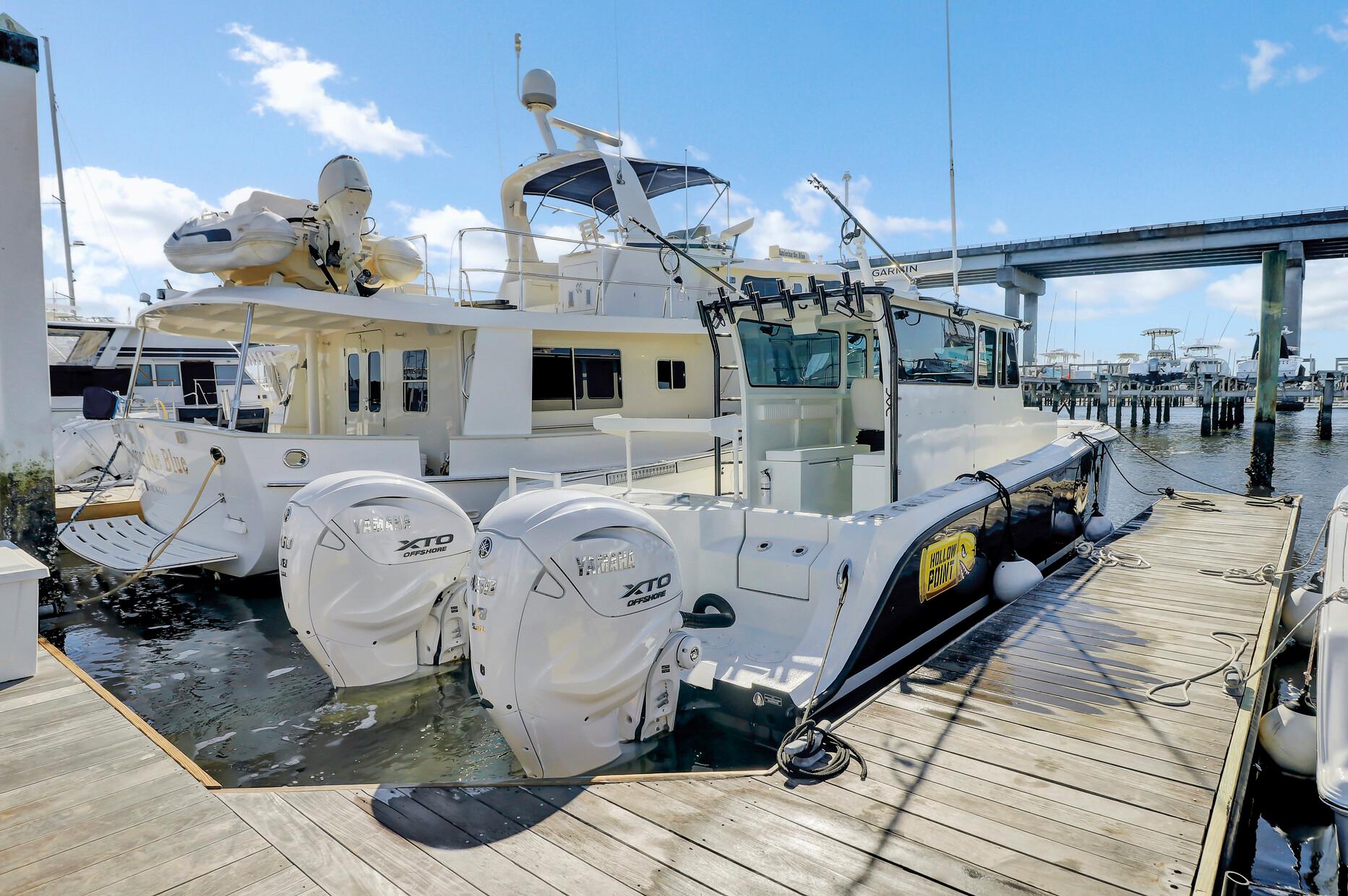 Custom 2024 Nerowalker boat docked with powerful twin engines, clear sky, and marina view.