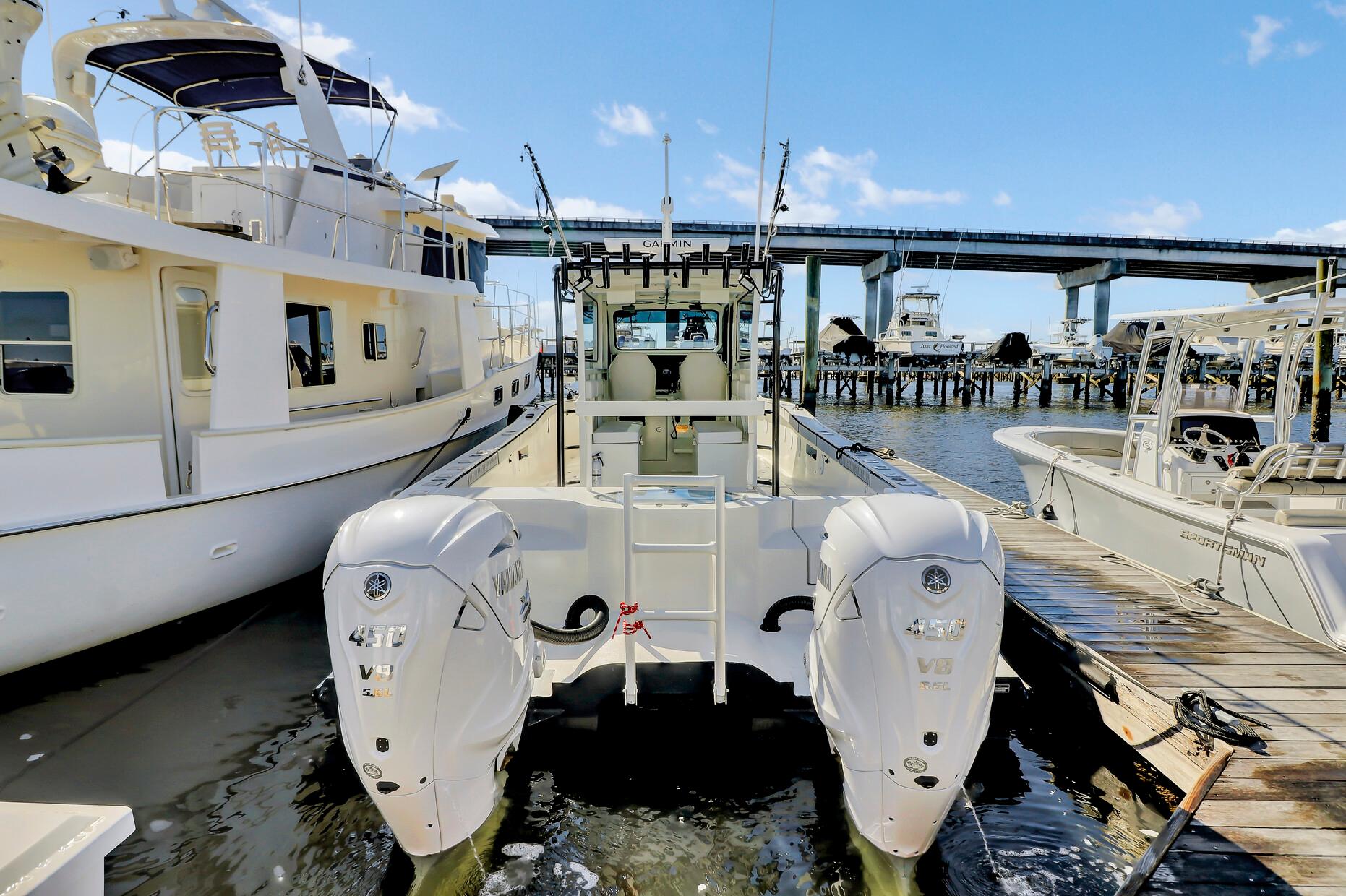 Custom Nerowalker 2024 boat docked with dual outboard engines, under a clear blue sky.