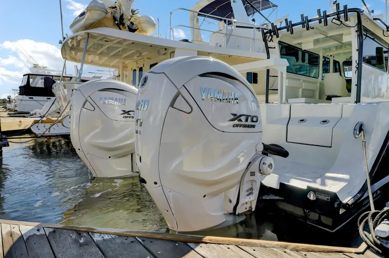 Our Trade Yacht Photos Pics Twin Yamaha XTO outboard engines on a 2024 Custom Nerowalker boat at a marina.