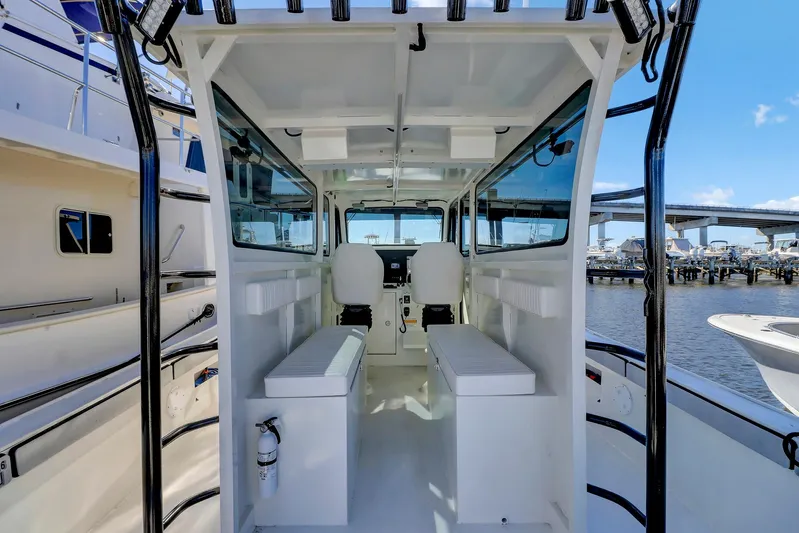 Our Trade Yacht Photos Pics 2024 Custom Nerowalker boat interior with seating, helm, and waterfront view.