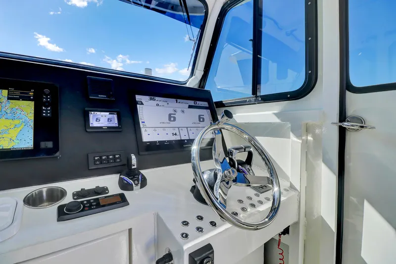 Our Trade Yacht Photos Pics Control panel of 2024 Custom Nerowalker boat with steering wheel and navigation screens.