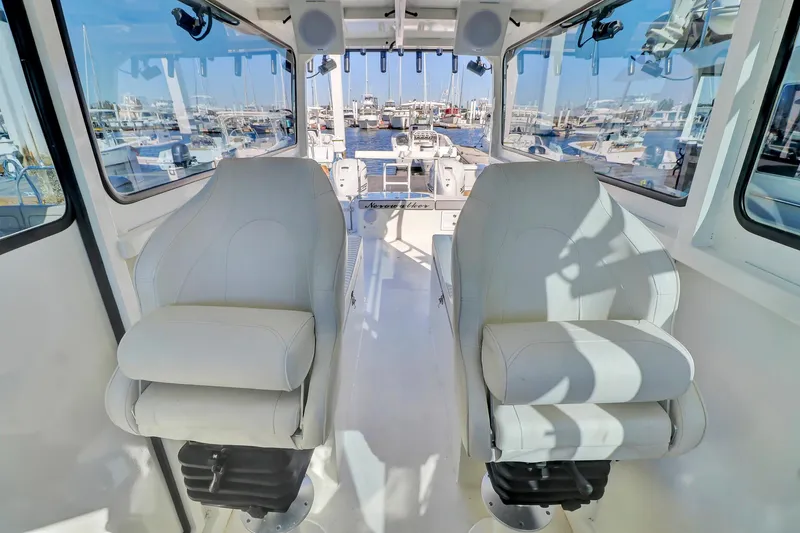 Our Trade Yacht Photos Pics Interior of 2024 Custom Nerowalker boat with two white captain chairs.