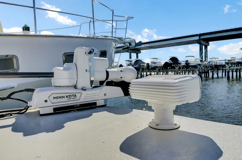 Our Trade Yacht Photos Pics Boat deck with Minn Kota motor, Custom Nerowalker 2024, near marina and bridge.