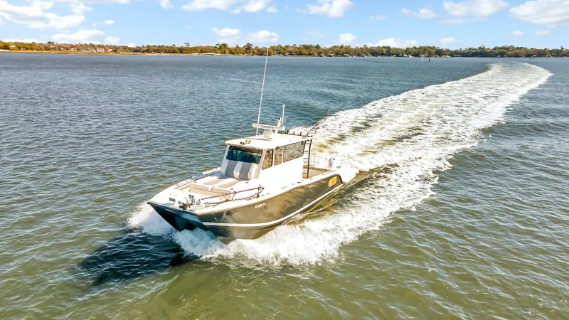 Our Trade Yacht Photos Pics Custom Nerowalker 2024 boat cruising on a sunny day, leaving a wake behind.