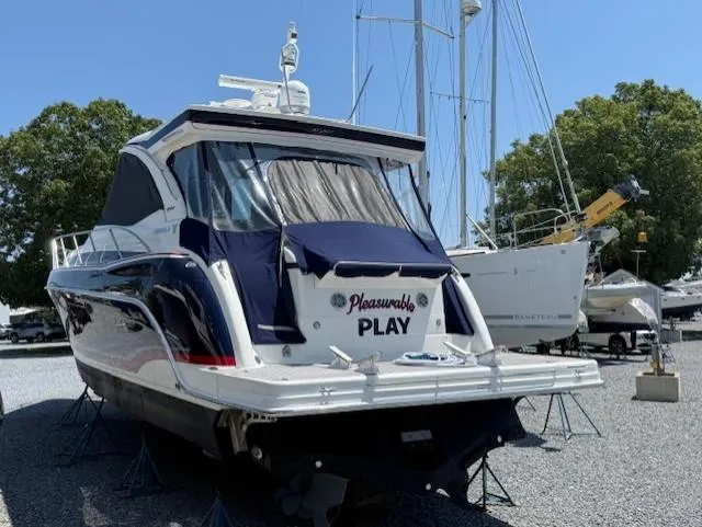  Yacht Photos Pics 2017 Formula 45 Yacht on stands, named "Pleasurable Play," in a boatyard setting.