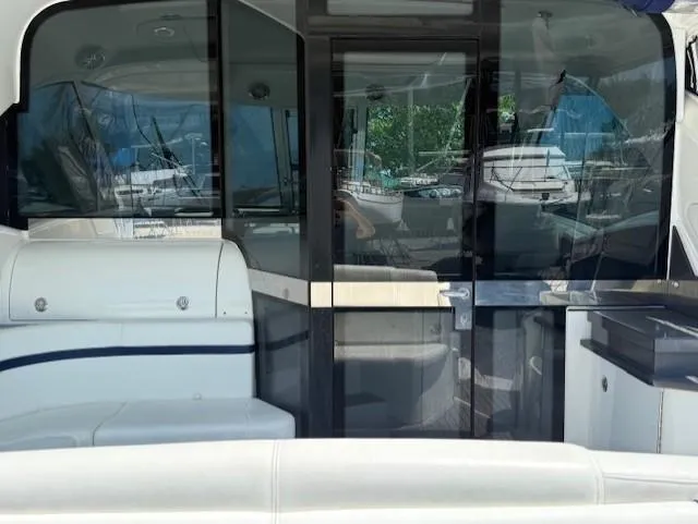 Yacht Photos Pics 2017 Formula 45 Yacht interior with sleek seating and glass doors, docked at a marina.