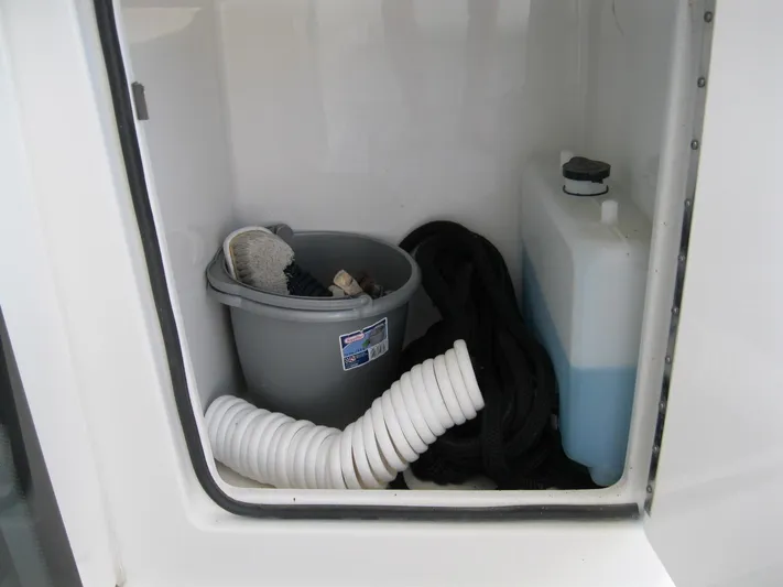  Yacht Photos Pics Storage compartment on 2017 Formula 45 Yacht with cleaning supplies and hose.
