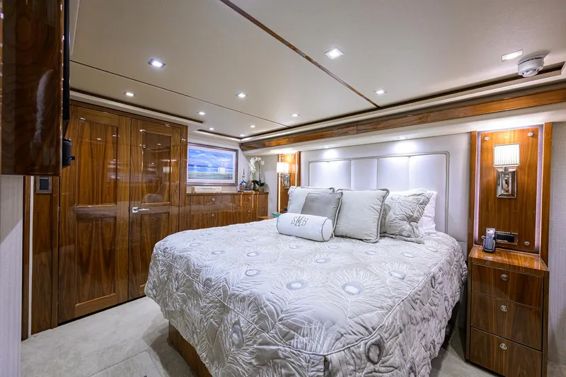 Sandbob II Yacht Photos Pics Luxurious bedroom interior of 2021 Viking 72 Convertible yacht with elegant wood finishes.