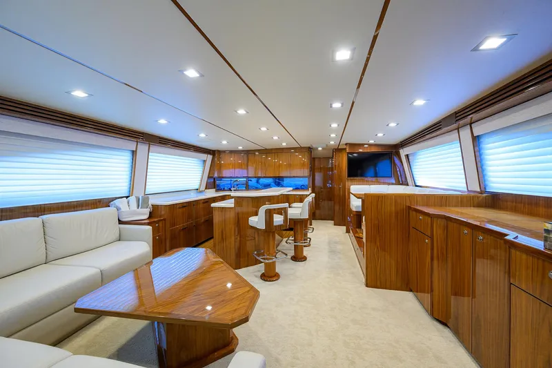 Sandbob II Yacht Photos Pics Luxurious interior of 2021 Viking 72 Convertible yacht with elegant wood finishes and modern seating.