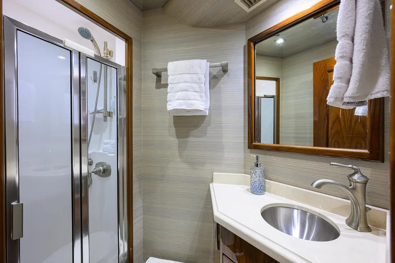 Sandbob II Yacht Photos Pics Luxurious bathroom in 2021 Viking 72 Convertible yacht with modern shower and sleek sink.