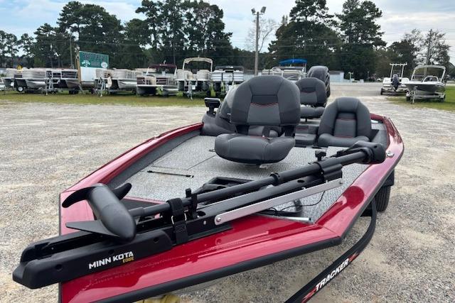 2023 Tracker Pro Team 175 TXW boat with Minn Kota trolling motor, parked outdoors.