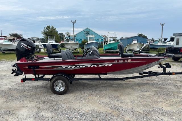 2023 Tracker Pro Team 175 TXW boat on trailer, parked outdoors, side view.
