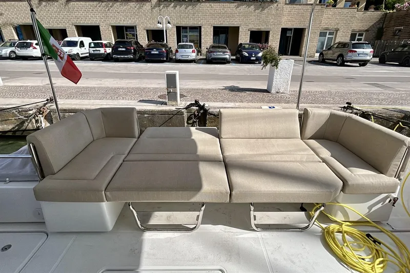  Yacht Photos Pics 2025 Fountaine Pajot MY4.S yacht with beige outdoor seating and Italian flag.