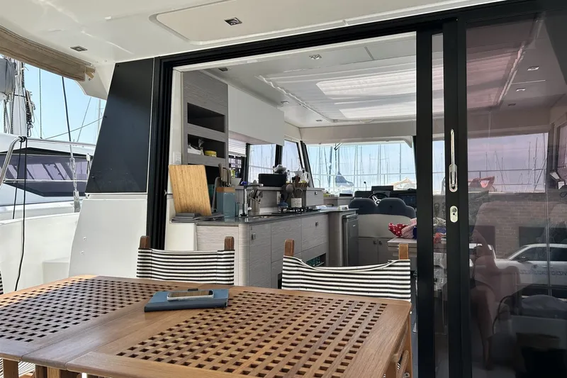  Yacht Photos Pics Luxurious 2025 Fountaine Pajot MY4.S yacht interior with modern kitchen and dining area.