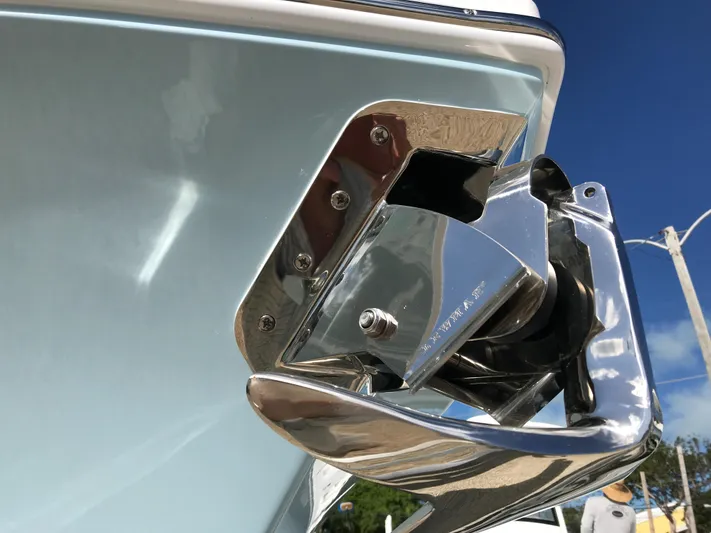Regulator 23 Carolina Blue Yacht Photos Pics Close-up of a 2023 Regulator 23 boat's polished anchor holder against a clear blue sky.