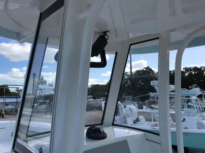 Regulator 23 Carolina Blue Yacht Photos Pics 2023 Regulator 23 boat interior with clear windows and outdoor view.