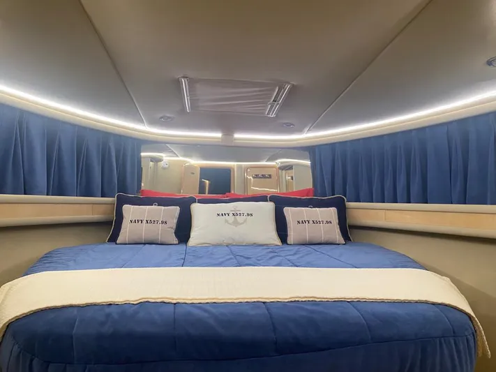  Yacht Photos Pics Luxurious bedroom interior of 2000 Sea Ray 515 Sedan Bridge yacht with blue bedding.