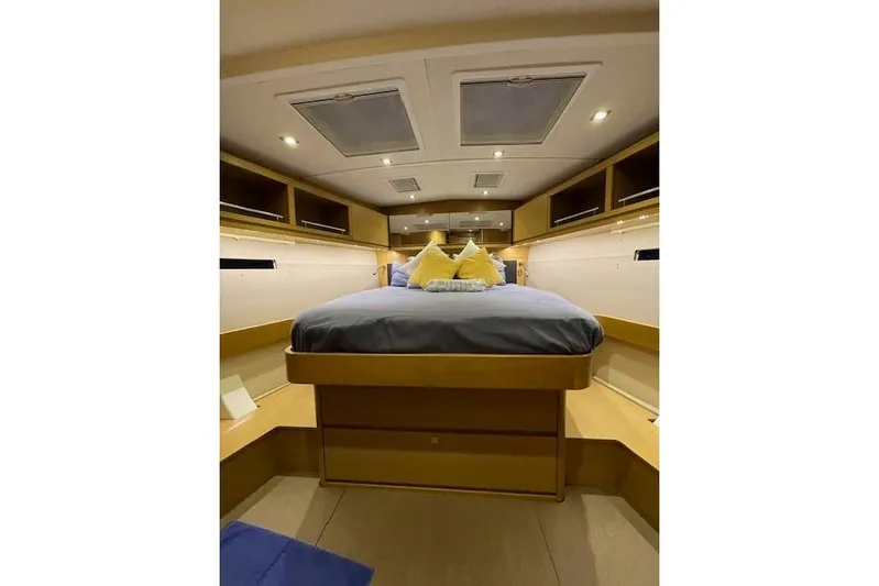  Yacht Photos Pics Luxurious cabin interior of 2015 Dufour 560 Grand Large yacht, featuring cozy bedding.