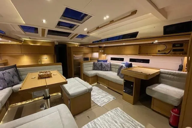  Yacht Photos Pics Luxurious interior of 2015 Dufour 560 Grand Large yacht with modern seating and skylights.