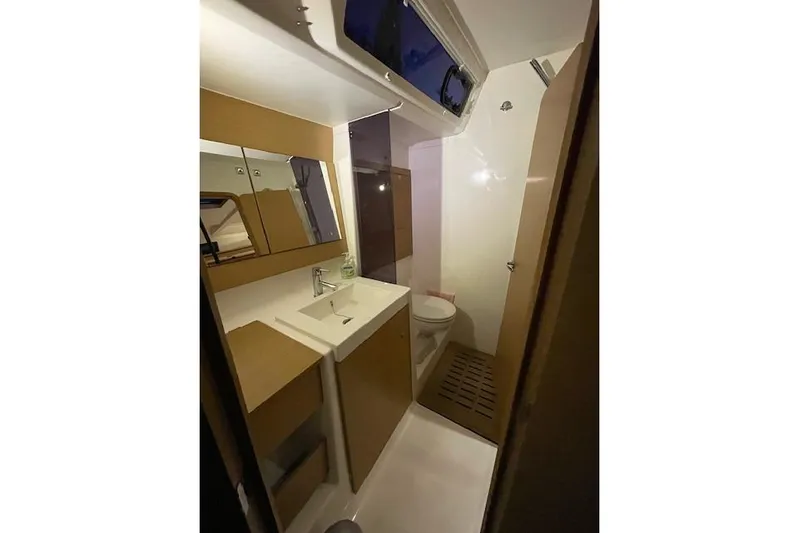  Yacht Photos Pics Bathroom interior of 2015 Dufour 560 Grand Large yacht, featuring modern fixtures and wood accents.