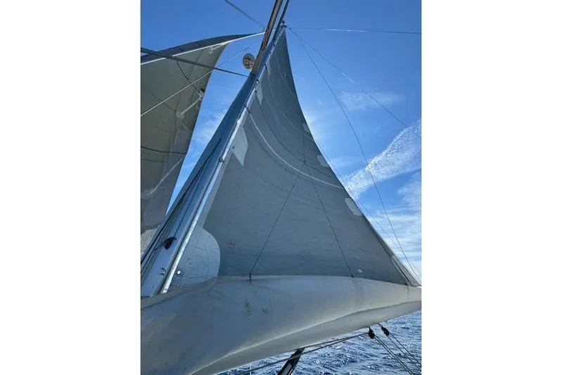  Yacht Photos Pics Sailing yacht Dufour 560 Grand Large 2015 with sails unfurled against blue sky.