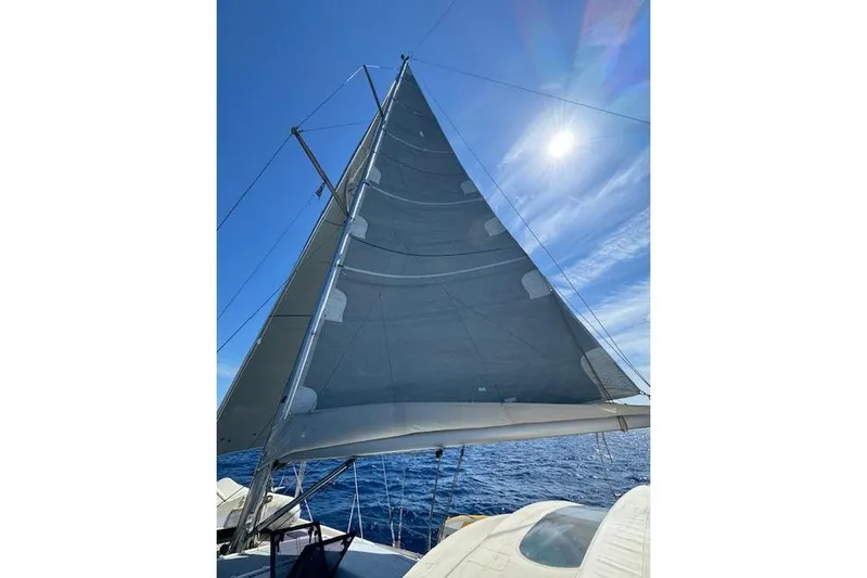  Yacht Photos Pics Sailing yacht Dufour 560 Grand Large 2015 with full sails under clear blue sky.