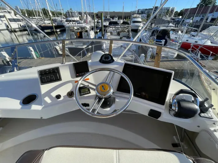 Elaine Hope Yacht Photos Pics Helm of 2017 Cutwater C-30 CB boat with marina view in background.