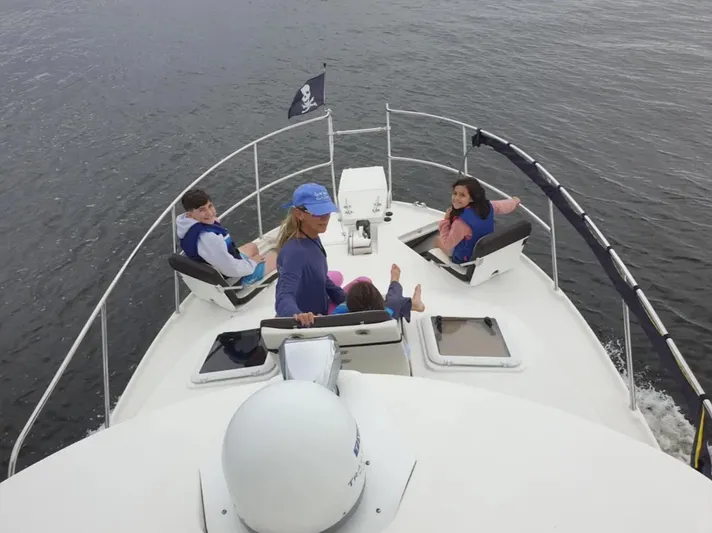 Elaine Hope Yacht Photos Pics People relaxing on a 2017 Cutwater C-30 CB boat deck, enjoying a calm water cruise.