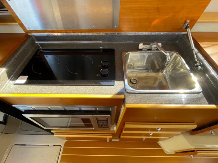 Elaine Hope Yacht Photos Pics 2017 Cutwater C-30 CB galley with stove, sink, and microwave in a compact layout.