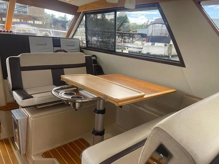 Elaine Hope Yacht Photos Pics Interior of 2017 Cutwater C-30 CB boat with seating and wooden table.