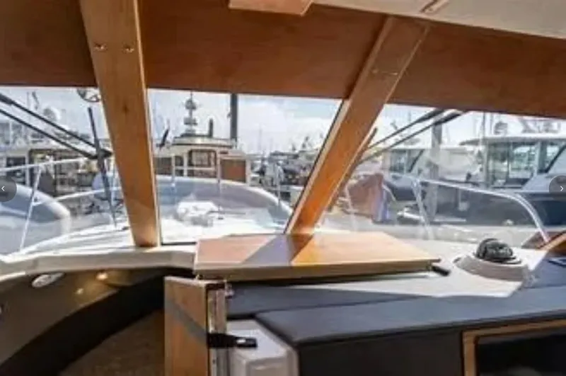 Elaine Hope Yacht Photos Pics Interior view of 2017 Cutwater C-30 CB boat, showcasing helm and marina background.