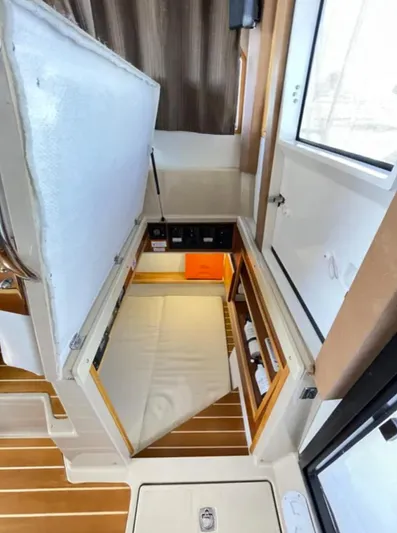 Elaine Hope Yacht Photos Pics 2017 Cutwater C-30 CB interior cabin with wood flooring and compact sleeping area.