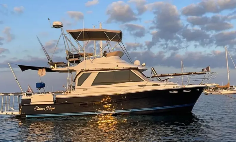 Elaine Hope Yacht Photos Pics 2017 Cutwater C-30 CB boat on water at sunset with cloudy sky.