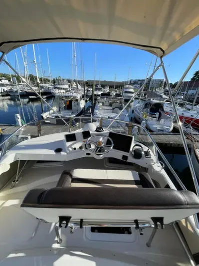 Elaine Hope Yacht Photos Pics 2017 Cutwater C-30 CB boat helm with marina view, featuring modern controls and seating.