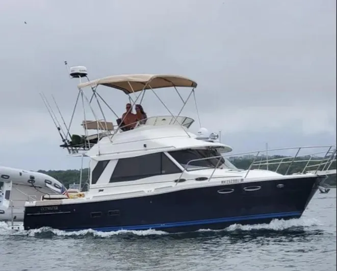 Elaine Hope Yacht Photos Pics 2017 Cutwater C-30 CB boat cruising on water with canopy and fishing rods.